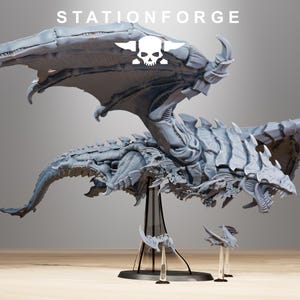 May include: A gray, detailed, 3D printed dragon model with wings outstretched. The dragon is posed in mid-flight and has a long tail. The model is on a clear plastic base. STATIONFORGE is printed in white letters at the top of the image.