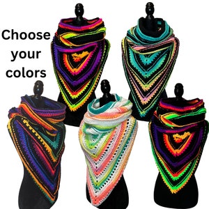 May include: Five crocheted triangular scarves in different color combinations. Each scarf features a black base with bright neon green, orange, pink, and purple accents. The scarves are displayed on mannequins with black bases.