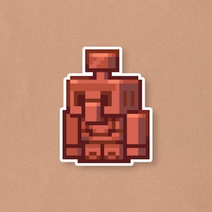 May include: A sticker featuring a pixelated, reddish-brown golem design with a white border. The golem has a blocky, geometric form, with a rectangular head and body, and square arms and legs. The sticker is on a tan background.