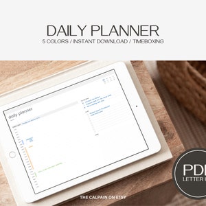 May include: A digital tablet displaying a daily planner template with a timeboxing feature. The planner is titled "daily planner" and has a light blue, orange, and green colour scheme. The text "DAILY PLANNER" is displayed above the tablet. The text "5 COLORS/INSTANT DOWNLOAD/TIMEBOXING" is displayed below the tablet. The text "THE CALPAIN ON ETSY" is displayed below the tablet. The text "PDF LETTER US" is displayed in a circle below the tablet.