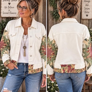 May include: A cream-colored denim jacket featuring long sleeves with a green, red, and yellow star-patterned fabric. The jacket includes a fold-over collar, button-front closure, two chest pockets, and a floral-patterned fabric band along the bottom hem.