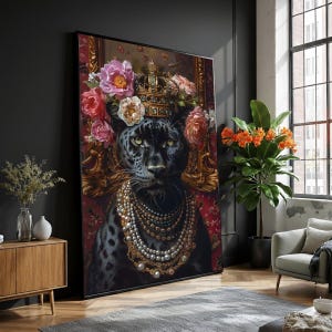 May include: A framed wall art print depicting a black panther wearing a gold crown and a floral headdress of pink and cream flowers. The panther is adorned with a pearl necklace. The background has a red floral pattern.