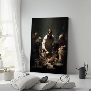 May include: A framed canvas print depicting a religious scene of a group of people gathered around a table. The central figure, dressed in white, is offering bread. The artwork has a dark, dramatic aesthetic with muted colors.