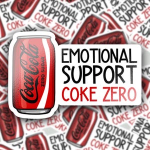 May include: A rectangular sticker featuring a red Coca-Cola Zero Sugar soda can illustration on the left and the black and red text "EMOTIONAL SUPPORT COKE ZERO" on the right, set against a background of multiple repeating stickers of the same design.