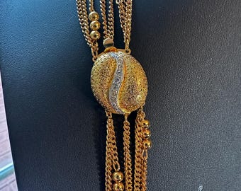Vintage 40” multi strand chain goldtone necklace. 8 chain stain necklace with decorative rhinestone swirl clasp. Unsigned