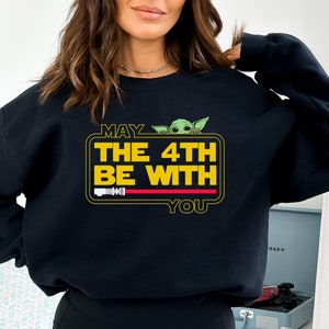 May include: Black sweatshirt with a yellow graphic that says "May the 4th be with you" and features a green character from Star Wars.