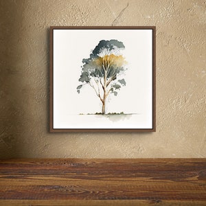 Puede incluir: Una pintura de acuarela enmarcada de un solo &aacute;rbol con un tronco marr&oacute;n y hojas verdes y amarillas sobre un fondo blanco.