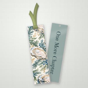 May include: Two rectangular bookmarks. One features a watercolor pattern of oysters, pine needles, and blue berries with a green ribbon at the top. The other is a solid sage green color with the text One More Chapter printed in dark gray.