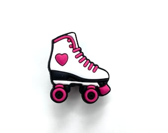 May include: White roller skate charm with pink wheels and a pink heart on the side.