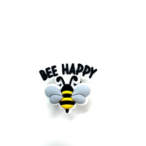 Könnte beinhalten: Eine schwarz-gelbe Biene mit grauen Flügeln und dem Text "Bee Happy" in Schwarz.