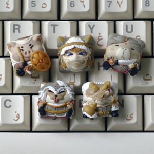 May include: A collection of custom keycaps featuring animal-themed designs. The keycaps depict a pig, a cat-like figure, a bear, a dog, and a crocodile, each in detailed costumes. The keycaps are placed on a white keyboard.