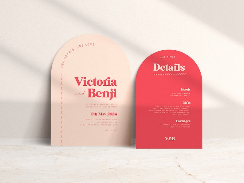 May include: Two pink and red arch-shaped wedding invitation cards with the text "Two Hearts, One Love" and "Victoria and Benji are getting married and would love for you to join the party" on the left card and "The Finer Details" with headings "Hotels", "Gifts", and "Carriages" on the right card.
