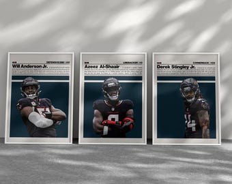 May include: Three framed posters featuring football players. Each poster has a portrait of a player in a black and red uniform, with text above identifying the player and their position. The posters are displayed against a gray background.