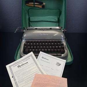 Vintage Optima Elite 3 Typewriter in Slate Grey No. 1069693, German QWERTZ, Functional & Serviced, 3+ Star Condition + Papers and Case