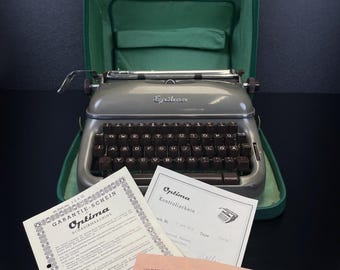 Vintage Optima Elite 3 Typewriter in Slate Gray No. 1069693, German QWERTZ, Functional & Serviced, 3+ Star Condition + Papers and Case