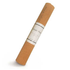 May include: Rolled cork and natural rubber yoga mat. The mat is light brown and has a white label with the text "Larga Vitae" and "Cork & Natural Rubber Yoga Mat". The mat measures 183 cm x 61 cm x 3 mm.