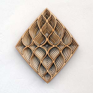 May include: A geometric wall art piece made of wood with a layered design of overlapping curves. The piece is diamond-shaped and has a light brown color.