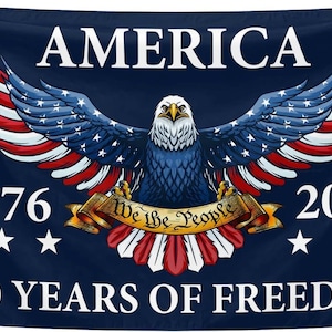 May include: A navy blue flag with the word "AMERICA" at the top. It features a bald eagle with outstretched wings, red and white stripes, and blue wings with white stars. The flag also includes the years 1776 and 2026, and the text "250 YEARS OF FREEDOM."
