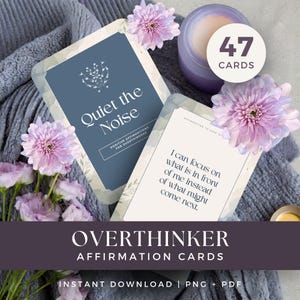 May include: A set of 47 affirmation cards for overthinkers, featuring a blue card with the text Quiet the Noise and a white card with the text I can focus on what is in front of me instead of what might come next, decorated with light purple flowers.