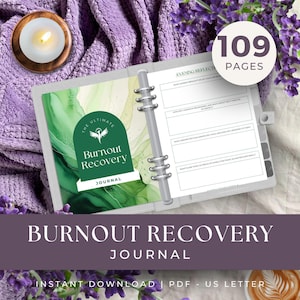 May include: A gray binder journal with the text "Burnout Recovery Journal" and "109 Pages". The journal has a green and white design on the cover and is open to a page with prompts. A lit candle and lavender are in the background.