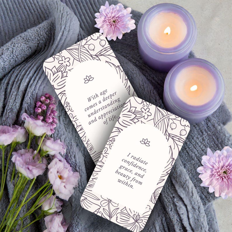 May include: Two white cards with inspirational quotes on them. The quotes are "With age comes a deeper understanding and appreciation of life." and "I radiate confidence, grace, and beauty from within."