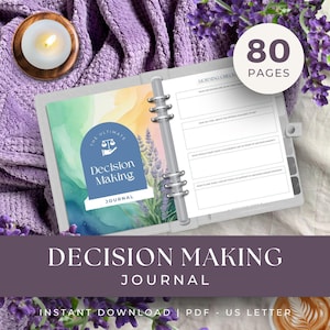 May include: A decision-making journal with a blue and green cover featuring the text "The Ultimate Decision Making Journal." The journal is open, revealing lined pages for notes. A circular graphic indicates 80 pages. The background includes a lit candle and lavender.