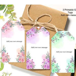 May include: Three printable gift tags with watercolor floral designs in pink, purple, and green. Each tag has a blank space for adding a personalized message. The text "Add own message" is printed on each tag.