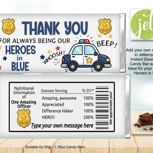 May include: A white candy bar wrapper featuring a police car graphic, gold badges, and the text THANK YOU FOR ALWAYS BEING OUR HEROES IN BLUE. The back includes a nutritional information label with text such as Amazing, Appreciated, and HERO!!