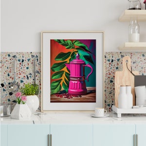 May include: Framed art print featuring a vibrant pink coffee maker with a handle, set against a backdrop of green leaves and coffee beans. The artwork has a colorful, stylized design, with a wooden table and a red, orange, and teal background.