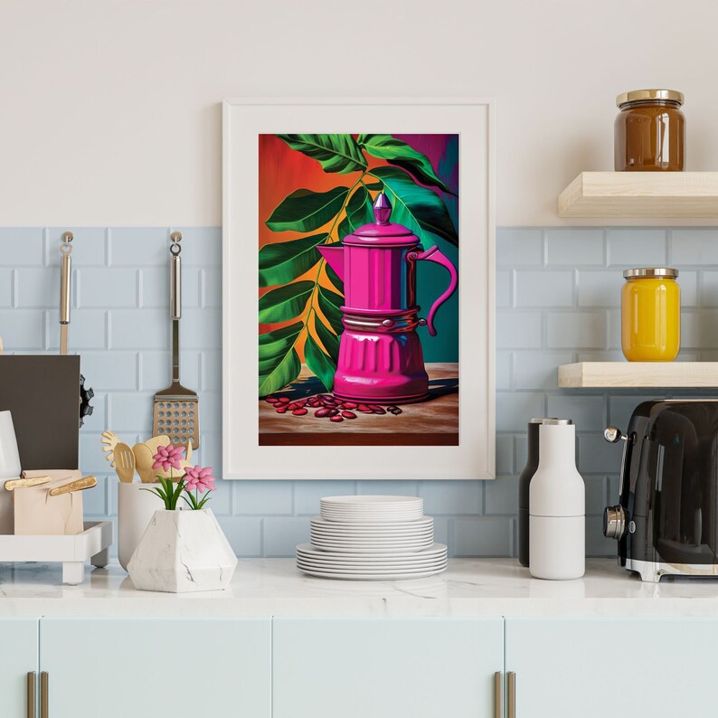 May include: A framed art print featuring a vibrant pink coffee maker with a green handle, set against a backdrop of lush green leaves and a colorful background. Scattered coffee beans add detail. The artwork is displayed in a kitchen setting.