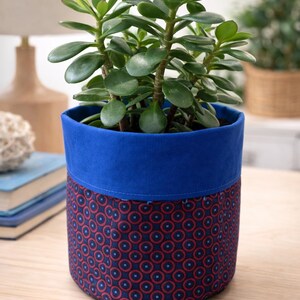 May include: A set of three ceramic mugs with a speckled, matte finish. The mugs are in shades of cream, light grey, and dark grey. Each mug has a simple, minimalist design, ideal for coffee or tea.