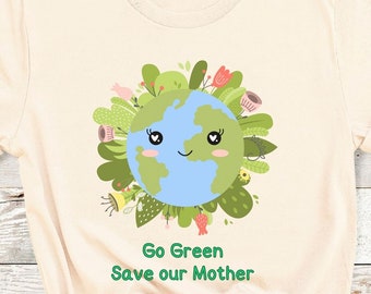 May include: A soft cream colored t-shirt with a cartoon image of the Earth with a smiling face surrounded by green leaves and flowers. The text "Go Green Save our Mother" is printed below the image.