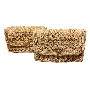 May include: Two rectangular beige woven straw handbags featuring a textured crochet pattern. One bag has a gold-toned hexagonal clasp, while the other features a gold-toned fan-shaped clasp centered on the front flap of each bag.