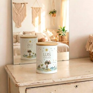 May include: White ceramic container with a wooden lid. The container features a cartoon pirate design with the name "LUIS" and the date "12.05.2022". The design includes a pirate, palm trees, a shark, and a sun.