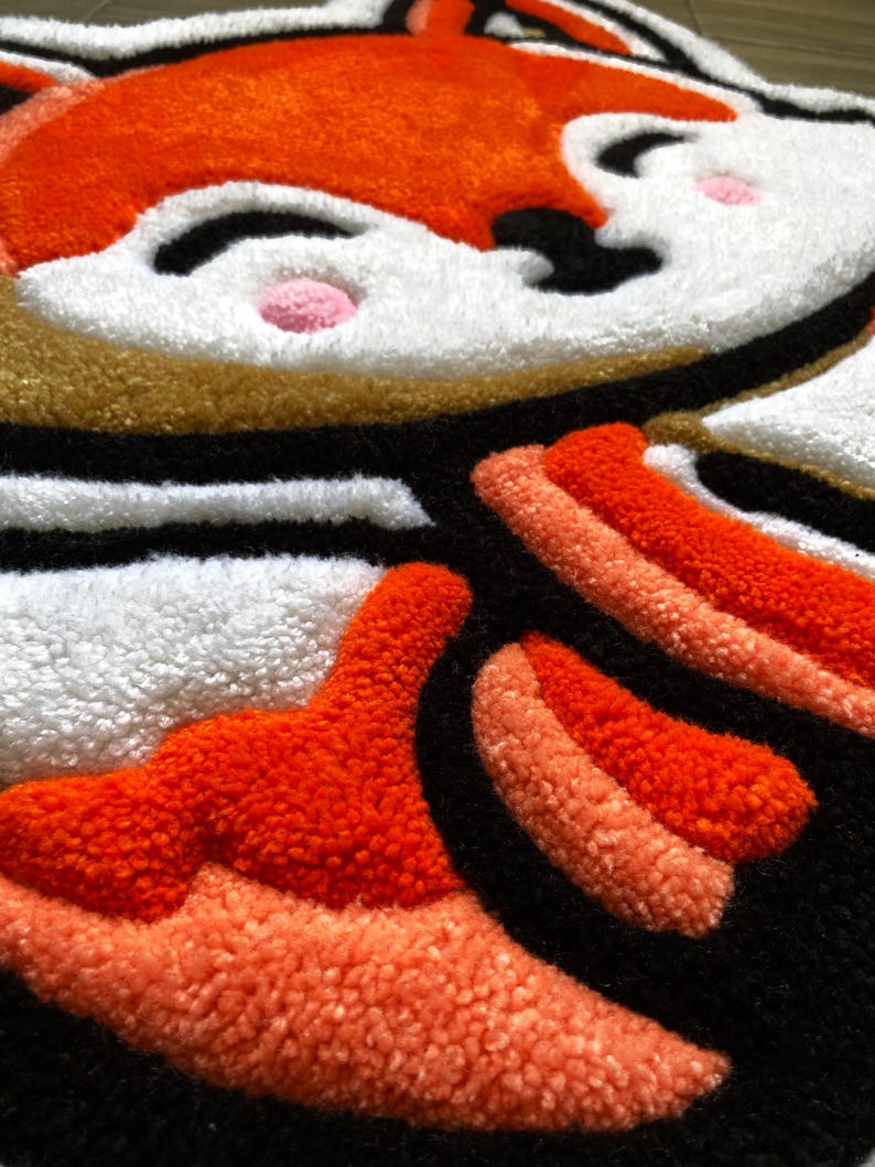 Detail of handmade tufted rug featuring red fox ears and plush texture – cozy kids decor