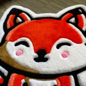 Vivid orange handmade fox rug close-up – soft tufted animal mat for playroom