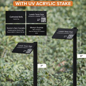 May include: Custom black aluminum plant tags with UV acrylic stakes. The rectangular tags feature white text and QR codes. Two stakes are shown with visible measurements of 7 inches and 9 inches. The text includes plant names like Laredo Texas Sage.