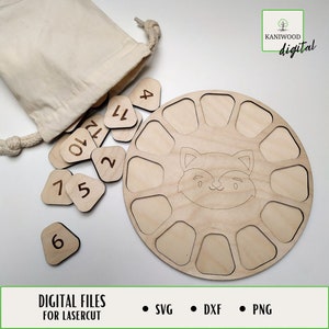 May include: A wooden number puzzle with a fox design. The puzzle includes a circular base with 12 slots and 12 individual number pieces. The number pieces are in a small white drawstring bag. The text "DIGITAL FILES FOR LASERCUT" and "SVG, DXF, PNG" are at the bottom of the image. The text "KANIWOOD digital" is in the upper right corner of the image.