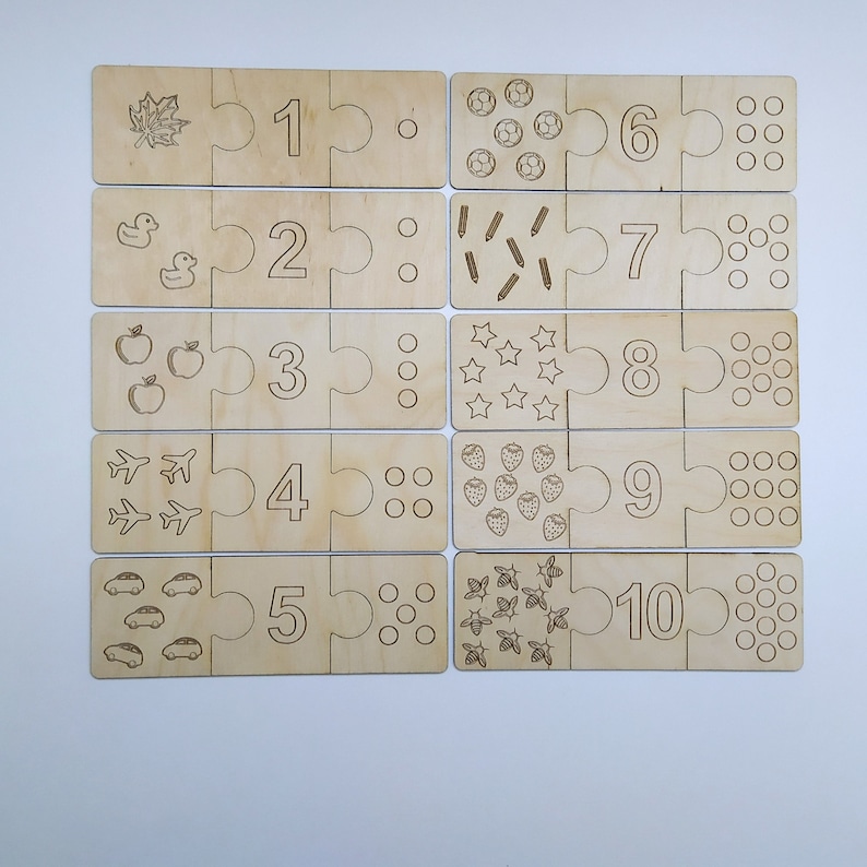 May include: Wooden puzzle pieces with numbers 1 through 10, each piece has a corresponding number of images, such as leaves, ducks, apples, airplanes, cars, soccer balls, pencils, stars, strawberries, and bees.
