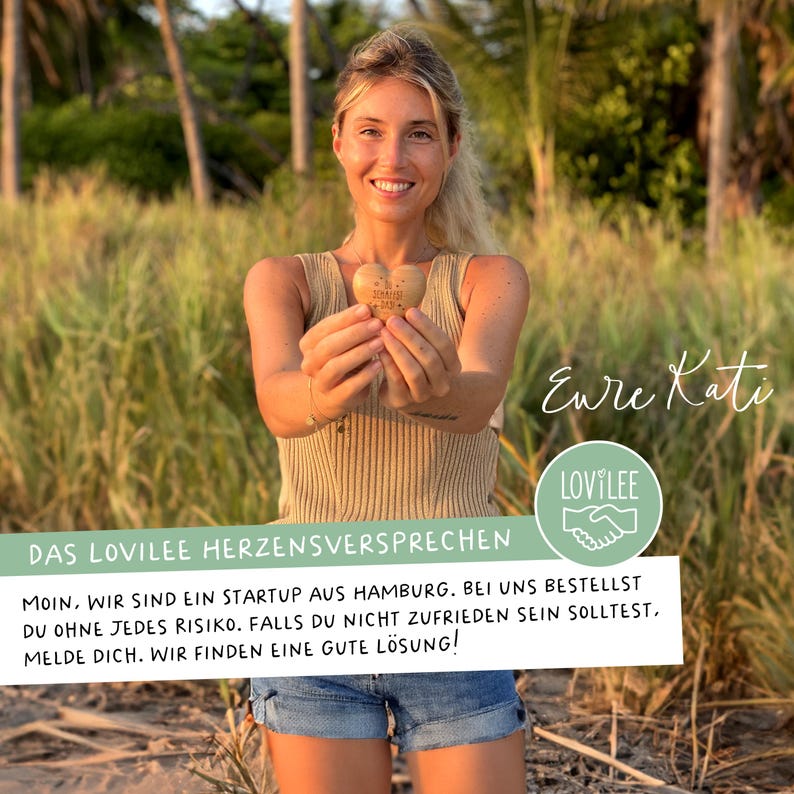 May include: A woman holding a wooden heart with the text "Handmade with love" engraved on it. The text "Eure Kati" and "LOVILEE" are also visible in the image. The text "DAS LOVILEE HERZENSVERSPRECHEN" is visible at the bottom of the image. The text below reads "Moin, wir sind ein Startup aus Hamburg. Bei uns bestellst du ohne jedes Risiko. Falls du nicht zufrieden sein solltest, melde dich. Wir finden eine gute L&ouml;sung!"