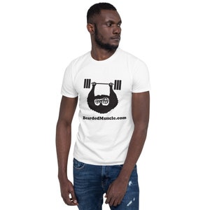 May include: A white t-shirt with a black illustration of a bearded man lifting a barbell. The text "BeardedMuscle.com" is printed below the illustration.