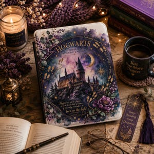 May include: A rectangular e-reader case featuring a watercolor illustration of Hogwarts castle against a purple and blue night sky. The text reads Hogwarts School of Witchcraft and Wizardry, I solemnly swear that I am up to no good, and Happiness can be found, even in the darkest of times, if one only remembers to turn on the light.