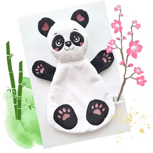 May include: A white plush panda baby toy with black and pink accents. The panda has a black nose, pink cheeks, and black eyes with pink hearts. The toy has black paws with pink paw pads.