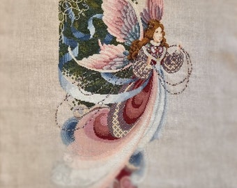 Cross-stitch painting depicting a young fairy