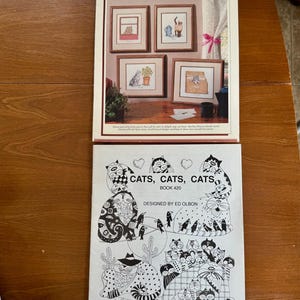 May include: Two craft books featuring cat-themed designs. The top book, "Cat Fancy," showcases framed cat illustrations. The bottom book, "Cats, Cats, Cats," by Ed Olbon, features black and white cat drawings and the text "BOOK 420."