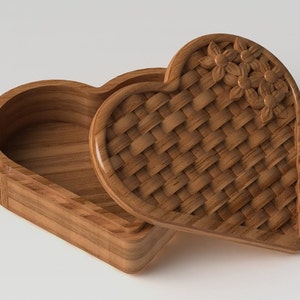 May include: A wooden heart-shaped box with a carved lid. The lid features a woven pattern and floral details.