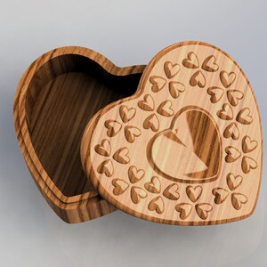 May include: A wooden heart-shaped box with a carved heart design on the lid. The box is open and the inside is visible.