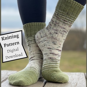 May include: A pair of green and white knit socks with a striped pattern. The socks are being worn by a person standing on a wooden surface. The text "Knitting Pattern Digital Download" is visible in the image.