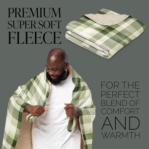 May include: A person is wrapped in a green and white plaid fleece blanket. The blanket is soft and warm, perfect for cuddling up on the couch. The text "FOR THE PERFECT BLEND OF COMFORT AND WARMTH" is written below the person.