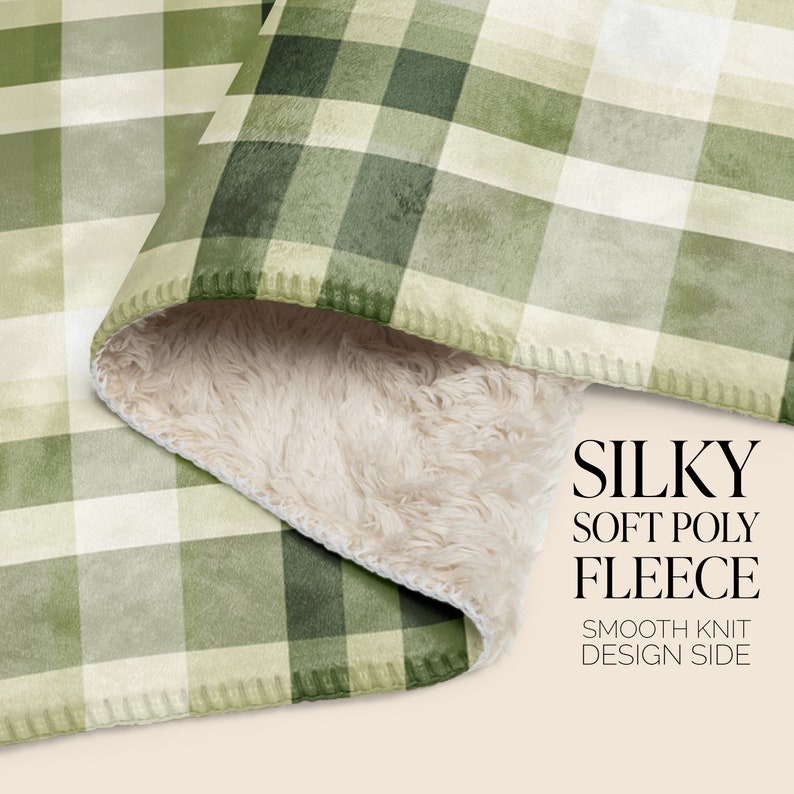 May include: A green and white plaid fleece blanket with a soft, fluffy white sherpa lining. The blanket is folded in half, showing both sides. The text "SILKY SOFT POLY FLEECE" and "SMOOTH KNIT DESIGN SIDE" is printed on the blanket.
